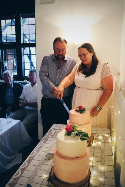 DIY Wedding Cake: The bride and groom cutting the cake